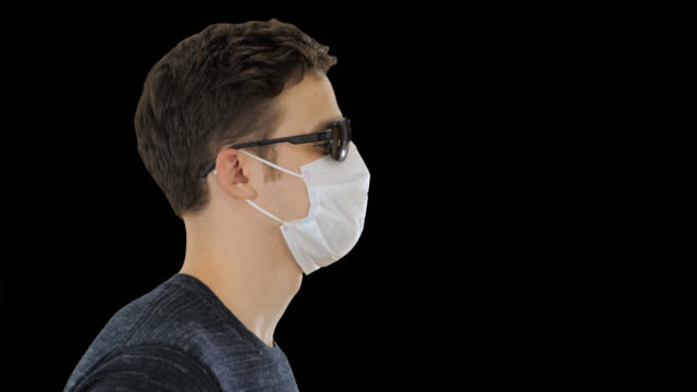 Blind man walking in medical mask and dark glasses, Alpha Channel
