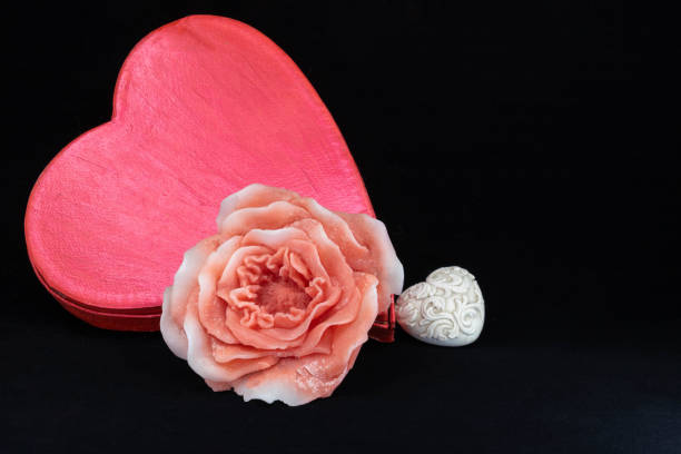 istock Make a romantic gift flower-shaped candle, white ceramic heart and red heart-shaped box 1222160216