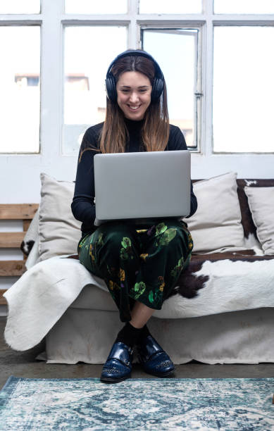 istock Woman sitting on sofa and using laptop. 1222163086