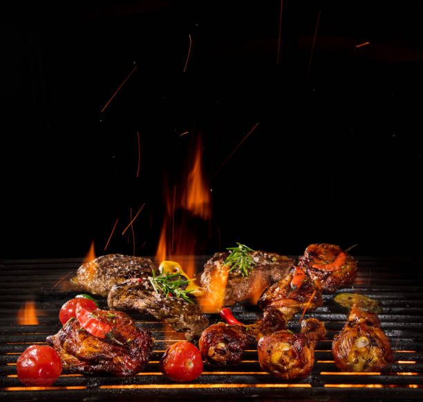 istock Chicken legs, wings and steaks on the grill. 1222164247