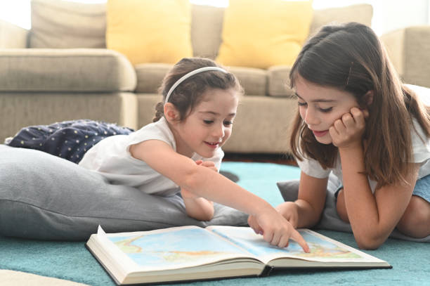 istock Girls reading a book together 1222164322