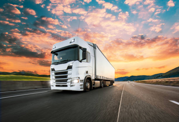 istock Truck with container on road, cargo transportation concept. 1222164545