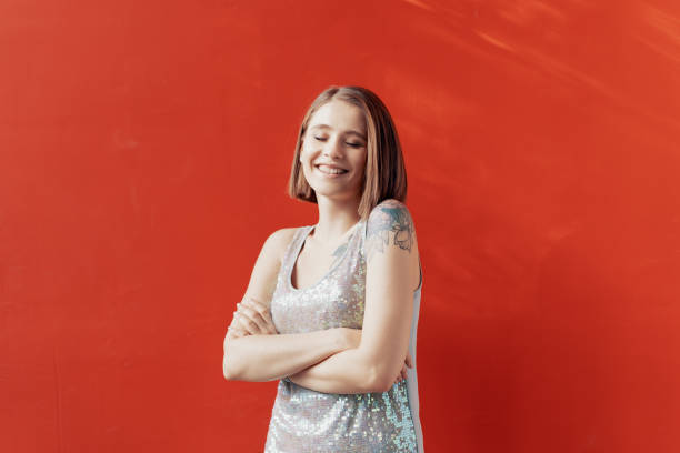 istock Cheerful young girl posing in front of a red wall 1222165444