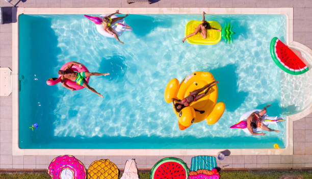 istock Friends having fun in a swimming pool 1222165499