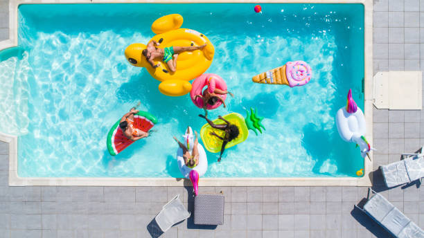 istock Friends having fun in a swimming pool 1222166070