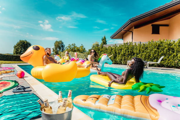 istock Friends having fun in a swimming pool 1222166992