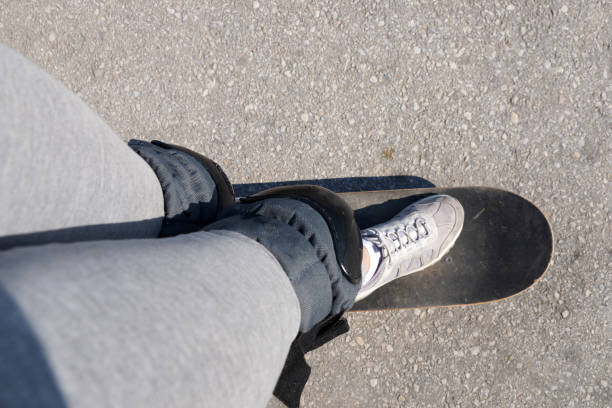 istock skateboarding, legs on a skateboard closeup, top view 1222167024