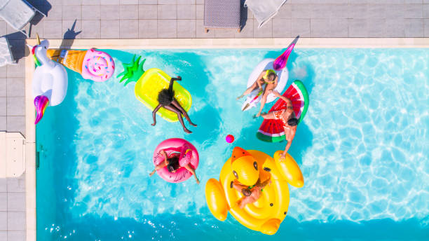 istock Friends having fun in a swimming pool 1222167083