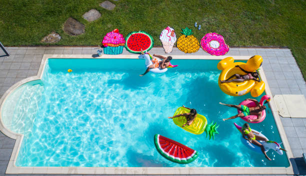 istock Friends having fun in a swimming pool 1222167155