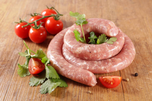 istock raw sausage with parsley and tomato 1222167291