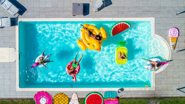 istock Friends having fun in a swimming pool 1222168403