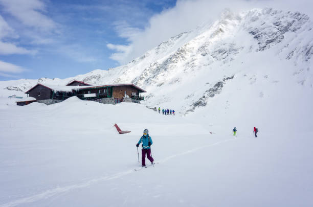 Skiers performing a group check of avalanche beacons Balea Lake, Fagarasi Mountains, Romania, 28.01.2020 - Skiers performing a group check of avalanche beacons avalanche beacon stock pictures, royalty-free photos & images