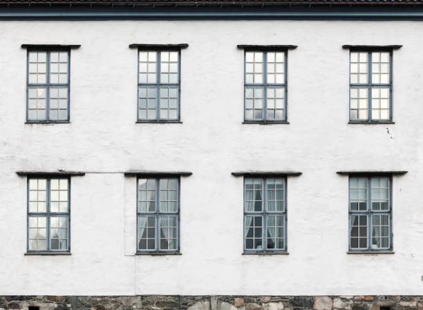 Old living house wall with windows, vintage facade details, background photo texture