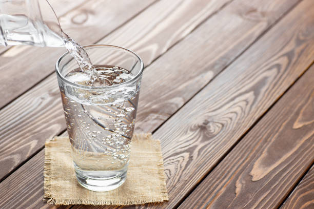 istock water pouring from jug into glass 1222168804