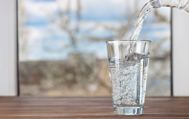 istock water pouring from jug into glass 1222168820