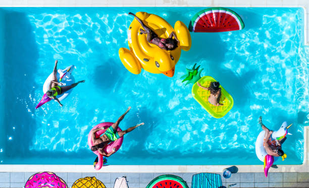 istock Friends having fun in a swimming pool 1222168826