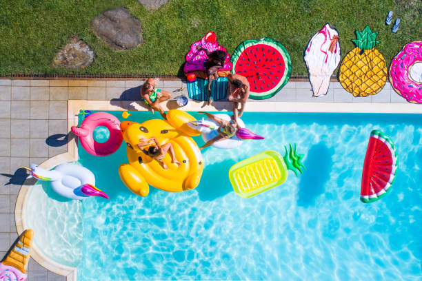 istock Friends having fun in a swimming pool 1222169427