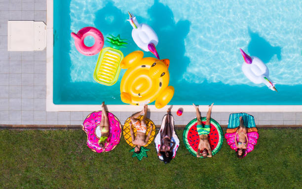 istock Friends having fun in a swimming pool 1222169650