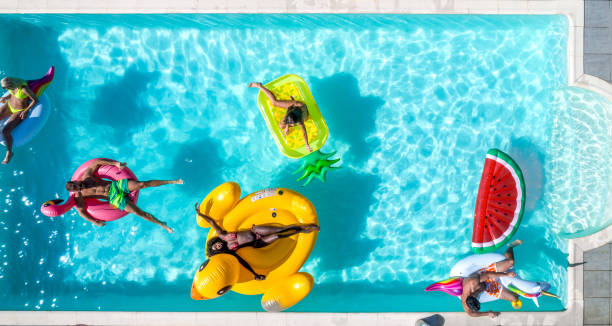 istock Friends having fun in a swimming pool 1222169919