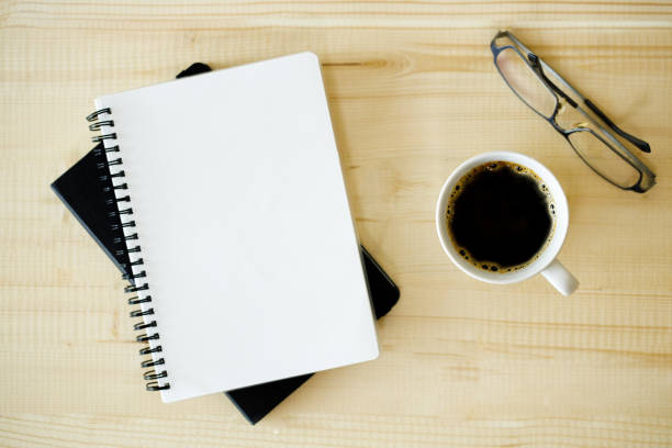 istock cup of hot coffee  on wooden background with notebook.  Work from home concept. 1222170274
