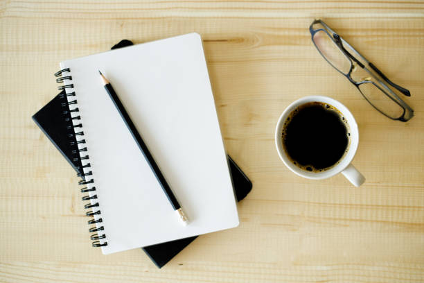 istock cup of hot coffee  on wooden background with notebook.  Work from home concept. 1222170276