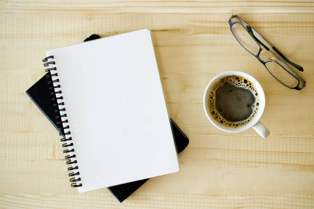istock cup of hot coffee  on wooden background with notebook.  Work from home concept. 1222170280
