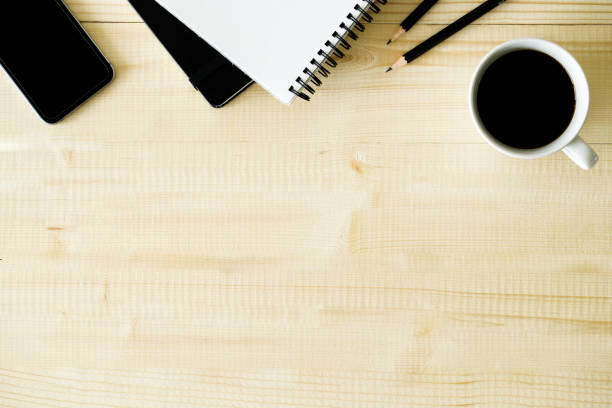 istock cup of hot coffee  on wooden background with notebook.  Work from home concept. 1222170298