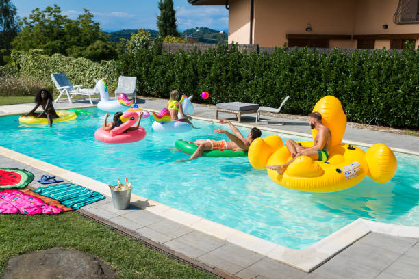 istock Friends having fun in a swimming pool 1222170394
