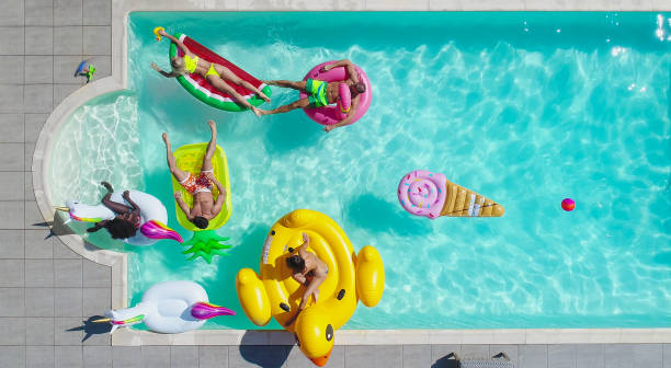 istock Friends having fun in a swimming pool 1222171369