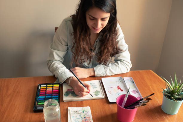 istock Lady painting leaves using watercolor technique from high-angle shot 1222172164