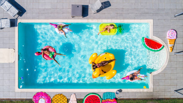 istock Friends having fun in a swimming pool 1222172199