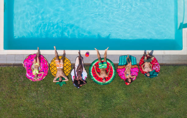 istock Friends having fun in a swimming pool 1222172305