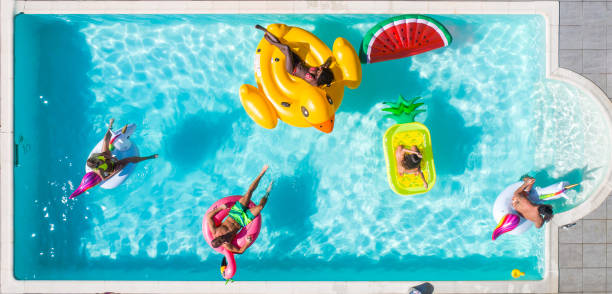 istock Friends having fun in a swimming pool 1222172387