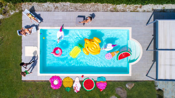 istock Friends having fun in a swimming pool 1222172724