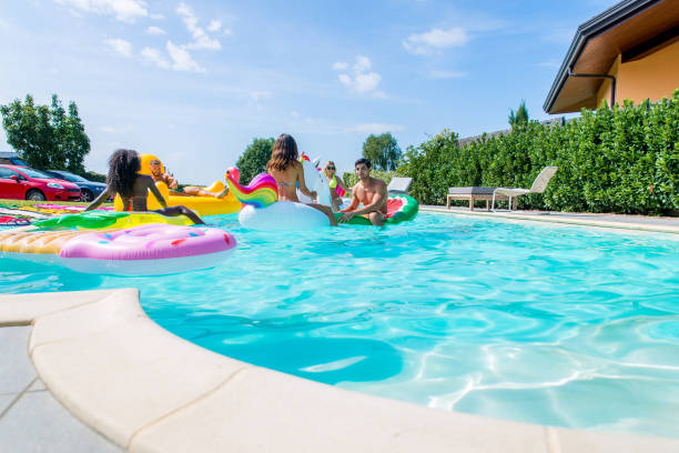 istock Friends having fun in a swimming pool 1222173437