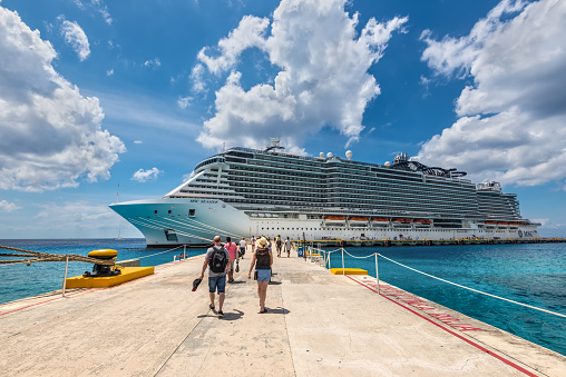 Cozumel, Mexico - April 24, 2019: Cruise passengers arrive to the cruise ship to check in and board the MSC Seaside Cruise Ship which sails from Cozumel to Miami.