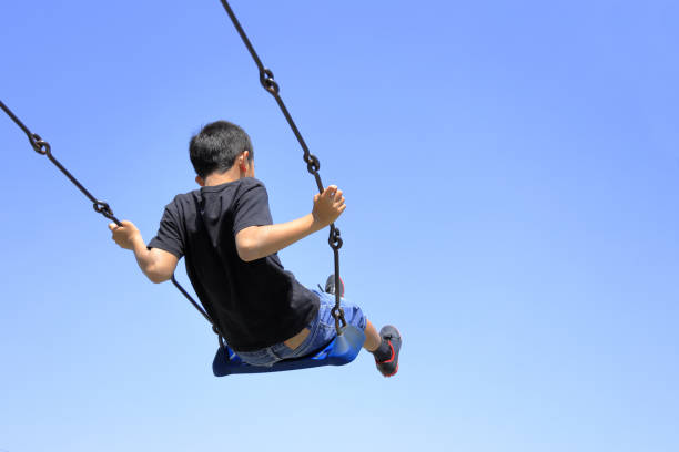 istock Japanese boy on the swing (appearance from behind) (fourth grade at elementary school) 1222173939