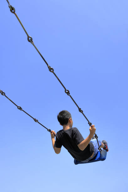 istock Japanese boy on the swing (appearance from behind) (fourth grade at elementary school) 1222173957