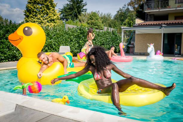 istock Friends having fun in a swimming pool 1222175038