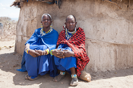 Arusha, Tanzania, november 1, 2019: Masai women in a traditional village  outside their mud hut