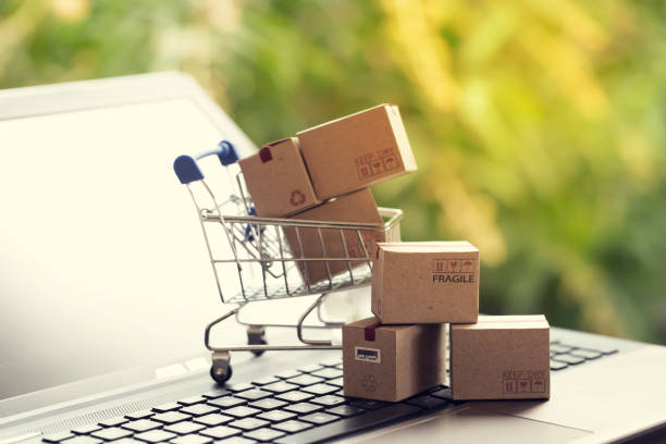 istock Paper boxes in a shopping cart on notebook keyboard. Ideas about e-commerce or electronic commerce is a transaction of buying or selling goods or services online over the internet. 1222176050