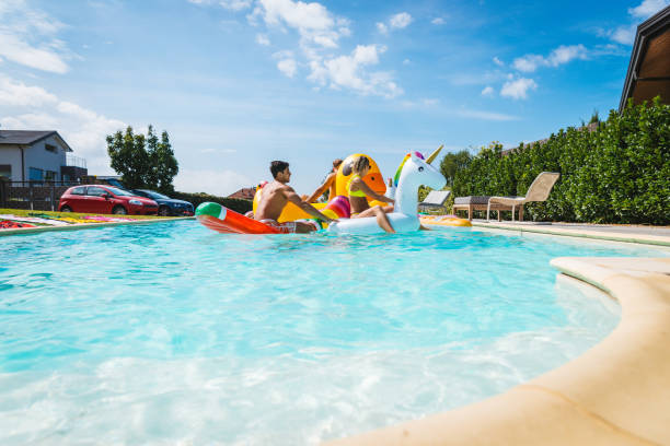 istock Friends having fun in a swimming pool 1222177677