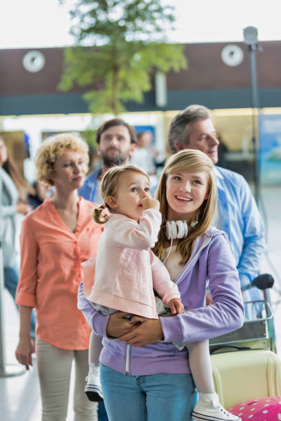 istock Family on holiday queueing for check in at airport 1222177713