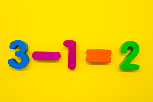 Subtraction of colorful numbers on yellow background