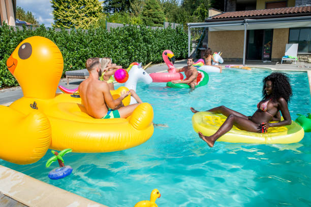 istock Friends having fun in a swimming pool 1222178461
