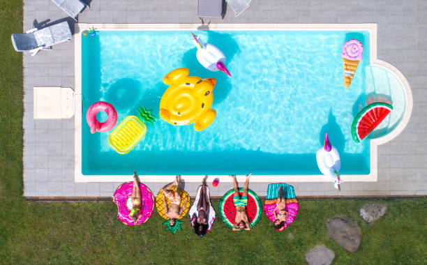 istock Friends having fun in a swimming pool 1222178847