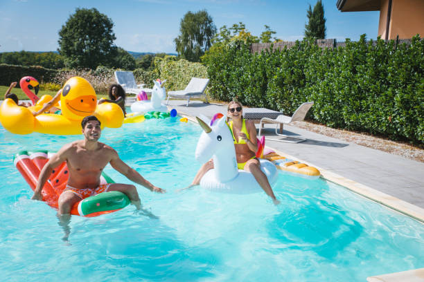istock Friends having fun in a swimming pool 1222179263