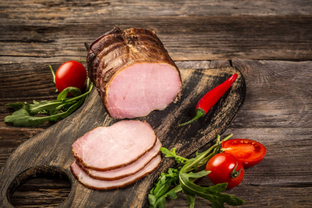 istock Cutted Ham Sausage on wooden background. cold meats 1222179893