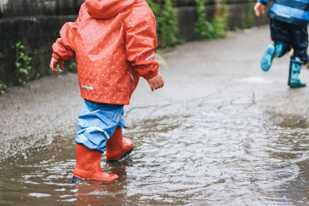 istock Kids playing  in the puddle 1222179950