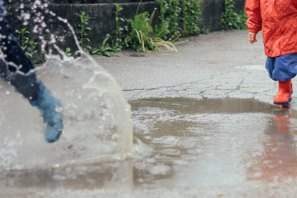 istock Kids playing  in the puddle 1222180328